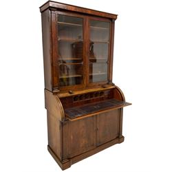 Victorian mahogany cylinder front bureau bookcase, moulded cornice over two glazed doors, the cylinder roll top opens to reveal sliding writing surface with leather insets, small drawers and pigeon holes, two panelled cupboards below with upright pilasters, on skirted base