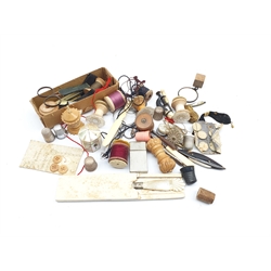 Box of vintage sewing items including three silver thimbles, mother of pearl thimble case, tape measures, reels etc