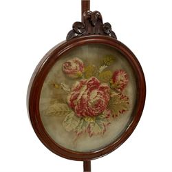 Victorian mahogany pole screen, circular moulded frame with flower head carving, needlework panel with raised plush rose head motifs and surrounding leafage, spiral turned column on three out-splayed supports with scroll carved terminals 