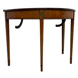 Sheraton period inlaid satinwood demi-lune dressing table, inlaid with a large central fan motif with projecting panels with segmented walnut panels, decorated with floral motifs and interlaced stringing, the top hinges to reveal an adjustable mirror and a combination of lidded compartments, on square tapering supports