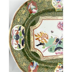 Pair of Victorian Ashworth Bros Ironstone meat plates decorated in the 'Trophy' pattern on green ground, impressed and printed marks, 44cm x 35cm