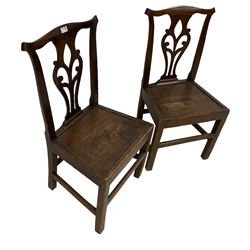 Pair Georgian elm country chairs, pierced splat back over panelled seat, raised on square supports