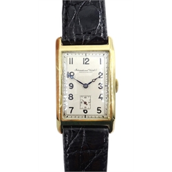 International Watch Co Schaffhausen 14ct gold 'curvex' wristwatch, c.1929, silvered dial, the hinged back case numbered 324192, on leather strap