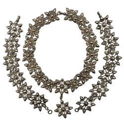 19th century cut steel necklace and pair of bracelets, possibly converted from a chatelaine, of foliate cluster links with faceted decoration (3)