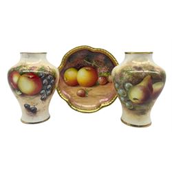Matched pair of Royal Worcester baluster form vases by Gerald Delaney and Roberts, each hand painted with a still life of fruit, with black printed marks beneath including shape number 2491, H10.4cm, together with a Worcester style shaped dish, hand painted with fruit by Leighton, signed beneath, D11.5cm (3)