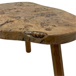 Beaverman - three-legged oak stool, the shaped figured burr top carved with beaver signature, on octagonal splayed supports, by Colin Almack, Sutton-under-Whitestone Cliffe, Thirsk