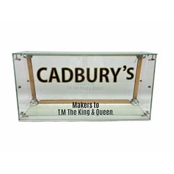 A vintage counter top confectionery glass cabinet with slope front and sliding glass doors to the back, bearing Cadbury's inscription, L76cm x H38cm 