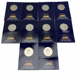 Eight Queen Elizabeth II United Kingdom fifty pence coins and two two pound coins, each housed in a 'Change Checker' card