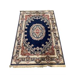 Traditional Middle Eastern design blue ground rug centred by a floral medallion, 273cm x 183cm