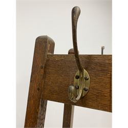 Early 20th century vintage oak hat and coat hall stand, four cast brass hooks raised on four splayed square section supports H177cm