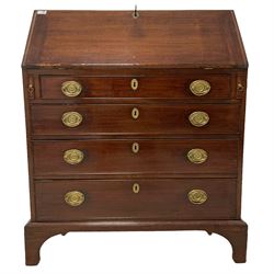 George III mahogany bureau, the fall-front enclosing fitted interior with later inlays, over four graduating cock-beaded drawers with pressed brass plates and drop handles, lower moulded edge over bracket feet