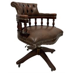 Chesterfield style captain's chair, upholstered in buttoned back brown leather, raised on a swivel base with castors 