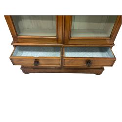 Victorian satin beech bookcase, two glazed doors opening to reveal six adjustable shelves over two short and two long drawers, raised on bun feet W119cm, H223cm, D36cm 