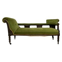Late 19th century walnut chaise longue, upholstered in green fabric, scrolled back with carved foliate decoration, on turned feet with castors