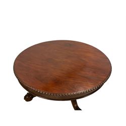 Mid-19th century Irish mahogany centre table, the circular top with gadroon moulded edge and banded frieze, raised on large turned pedestal with carved foliate insets, the large cabriole supports with moulded acanthus leaf decoration terminating in ball and claw feet with castors 