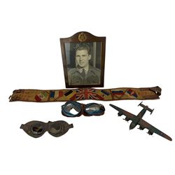 Military leather belt inscribed in cross stitch 'Pte M Pavey K.O.Y.L.I.' and Allied flags etc, RAF photograph frame, two pairs of goggles and a wooden model of a bomber (5)