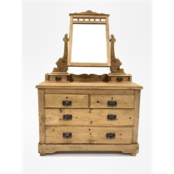 Edwardian pine dressing chest, the bevelled swing mirror raised on two floral carved uprights over two trinket drawers, two short and two long graduated drawers under 