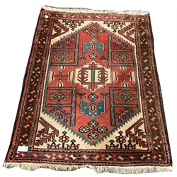 Persian design red ground rug, with stylised geometric and floral decoration on red field, 112cm x 150cm