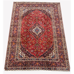 Persian fine Kashan red ground carpet, with floral medallion on red field with interlaced foliate, triple guarded border, 357cm x 254cm