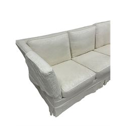 Three seat sofa, upholstered in cream cotton with floral and foliate design, raised on turned bun feet