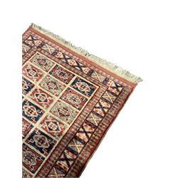 Persian design red ground runner rug, the field decorated with rectangular panels of indigo and red containing lozenge motifs, guarded border with repeating cross patterns