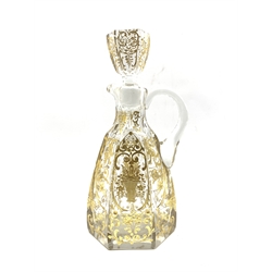 Early 20th century French glass claret jug of hexagonal design incised and gilded with trailing foliage, baskets of flowers and with cut loop handle H28cm