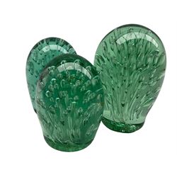 Victorian green glass dump paperweight with elongated bubble inclusions H15cm and two other very similar paperweights H13cm and 10cm (3)