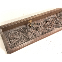 Early 20th century oak wall hanging coat rack, the back relief carved with oak leaves and acorns, fitted with two three spoke hooks, W90cm