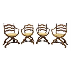 Set four late 19th century walnut x-framed throne type chairs, three shaped horizontals over seats upholstered in gold damask fabric, the uprights set with turned finials, curved front rails on shaped supports joined by curved x-framed stretchers, the fronts set with turned roundels 