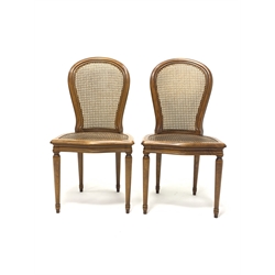 Pair French style bergère chairs, moulded beech frames, curved cane work backs and serpentine seats, turned supports