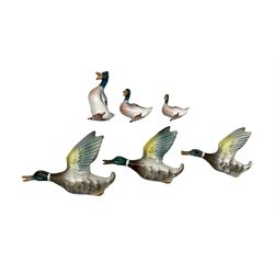Set of three graduated flying mallards by Keele Pottery, together with a set of three further pottery mallards