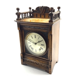  Late 19th century oak cased mantel clock, galleried top with shield and scroll carved raised back, the front carved with lunettes and cross hatched decoration, silvered circular Roman dial, twin train 'Winterhalder and Hofmeier' movement striking the hours and half and single coil, the movement stamp 'W&H, Sch', H37cm  