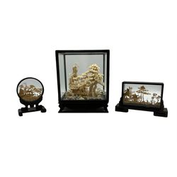 Chinese carved cork diorama scene depicting pavilion on lake with cranes in ebonised case together with two others max 30cm