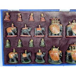20th Century Indian carved wooden, painted and gilt figural chess set in velvet case