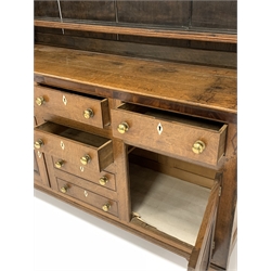 19th century oak and mahogany banded dresser, projecting cornice over pierced frieze on three height plate rack, four drawers, two faux drawers and two fielded cupboards to base, raised on shaped bracket supports