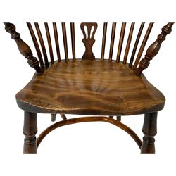 Early 19th century elm and yew wood Windsor armchair, low stick back with pierced splat, dished seat on turned supports joined by crinoline stretcher