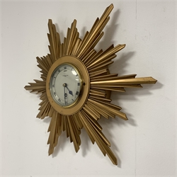 Elliot Giltwood starburst wall clock with silvered dial and Roman numeral chapter ring, retailed by W. Green and Sons, Leeds, eight day single train movement, W45cm
