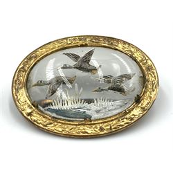 Essex crystal oval Mizpah brooch reverse painted with ducks in flight in a gilt metal frame