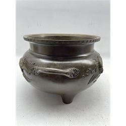 19th century Japanese bronze two handled jardiniere decorated with a raised pattern of dragons etc and with interior decoration on three short feet D30cm