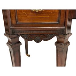 Late 19th century mahogany writing desk, rectangular moulded top with serpentine break-front, tooled leather inset, fitted with three drawers and two cupboards, the central drawer with flower head carving, scrolled acanthus leaf brackets, canted upright corners with fluted decoration, on square tapering supports with recessed panels and spade feet, brass cups and castors 