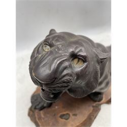 Large Japanese patinated bronze of a tiger, Meiji period, crouching with open mouth, signature mark, on wooden base, L64cm 