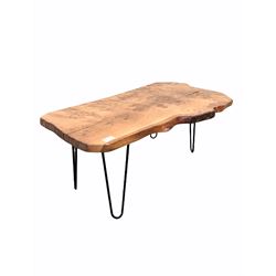 Contemporary rustic coffee table, the burr hardwood top with live edge raised on hairpin supports W91cm