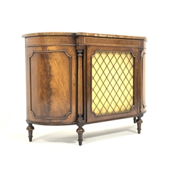 Regency style mahogany break bow front chiffonier side cabinet, rosewood cross banded top over boxwood stringing to frieze, brass grill and silk curtain to centre door, enclosed by turned pilasters and two panelled cupboards, raised on turned supports, W122cm, H85cm, D40cm