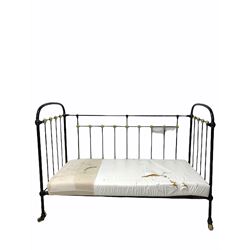 Victorian child's cot, the black and gilt painted wrought iron frame raised on castors, with a later foam mattress L137cm