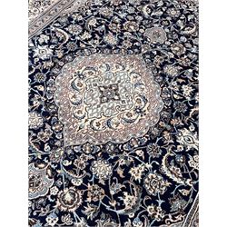 Persian Nain ivory ground rug, shaped blue ground field decorated with medallion and surrounded by interlaced foliate and stylised flower head motifs, repeating border in scrolling design, with silk inlay 
