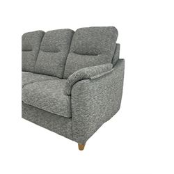 G-Plan - three seat sofa upholstered in grey fabric, raised on turned supports 