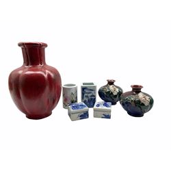 Pair of Oriental lobed form vases applied with water lilies on a blue, red and green glazed ground, H14cm, a lobed red glazed vase, a Chinese porcelain brush pot decorated with flowers and birds, two blue and white square lidded dishes and covers and a matched vase 