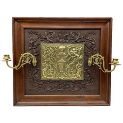 Arts and Crafts design wall panel with a raised pattern of leaves and flowers inset with an embossed brass panel with folding candle sconces 51cm x 57cm 