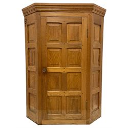 Beaverman - oak corner cupboard, moulded cornice over enclosed by panelled door and sides, the interior fitted with shelves, carved Yorkshire Rose handle and beaver signature, by Colin Almack, Sutton-under-Whitestone Cliffe, Thirsk