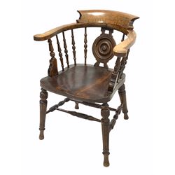 Late Victorian oak smokers bow armchair, with turned splat and spindle gallery over shaped seat, raised on turned supports united by double 'H' stretcher W61cm